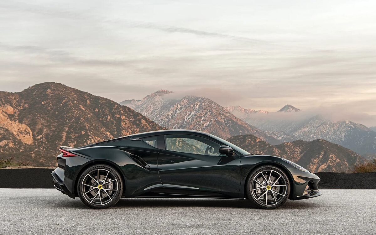 Lotus Emira in dark green, side profile on a mountain road