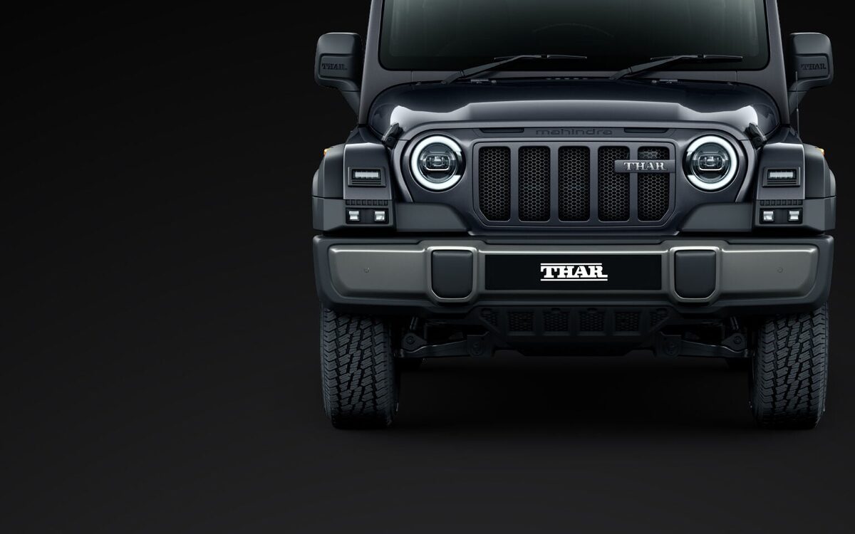 Front of the Mahindra Thar showing round LED headlamps, seven-slot grille and bumper