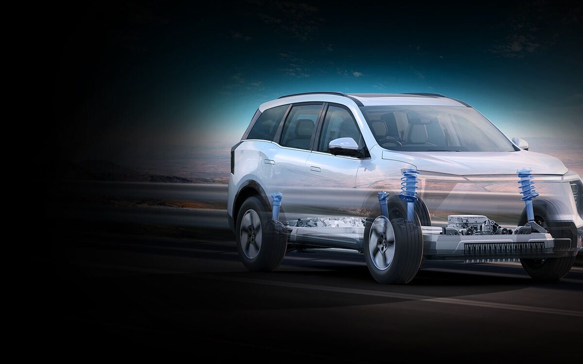 Mahindra XEV 9S in white with a see-through view of the suspension and battery floor