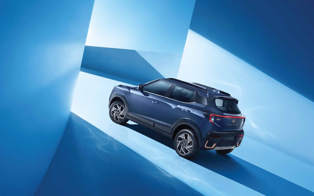 Mahindra XUV 3XO EV in blue, rear three-quarter view with the copper rear lamp bar