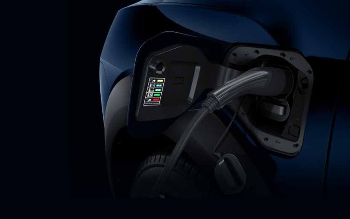 Close-up of the XUV 3XO EV charging flap open with a charging cable plugged in and the status lights lit