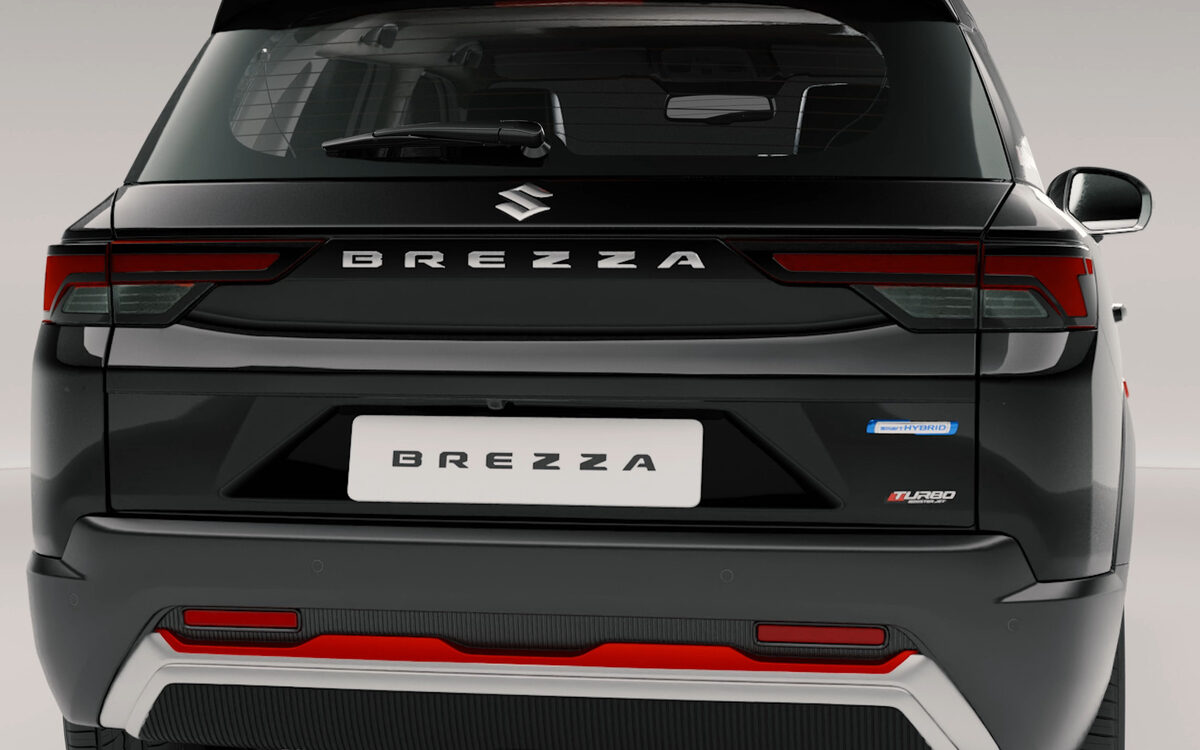 Close view of the rear of a black Brezza showing the tail lamps, tailgate badge and rear skid plate
