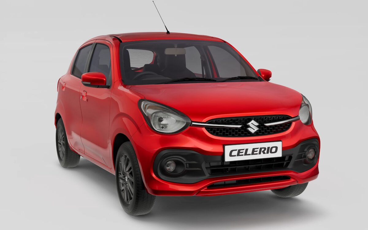 Maruti Suzuki Celerio in Fire Red, front three-quarter view on a plain grey studio background