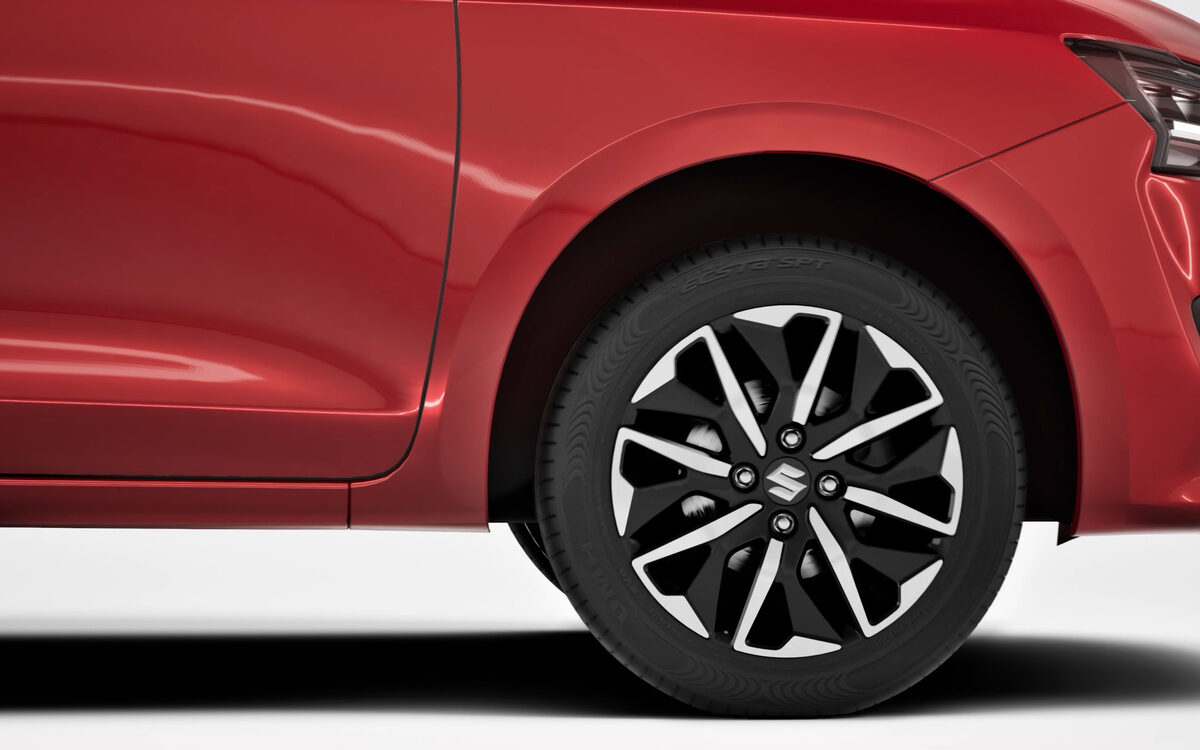 Close-up of the Dzire's two-tone alloy wheel and front wheel arch