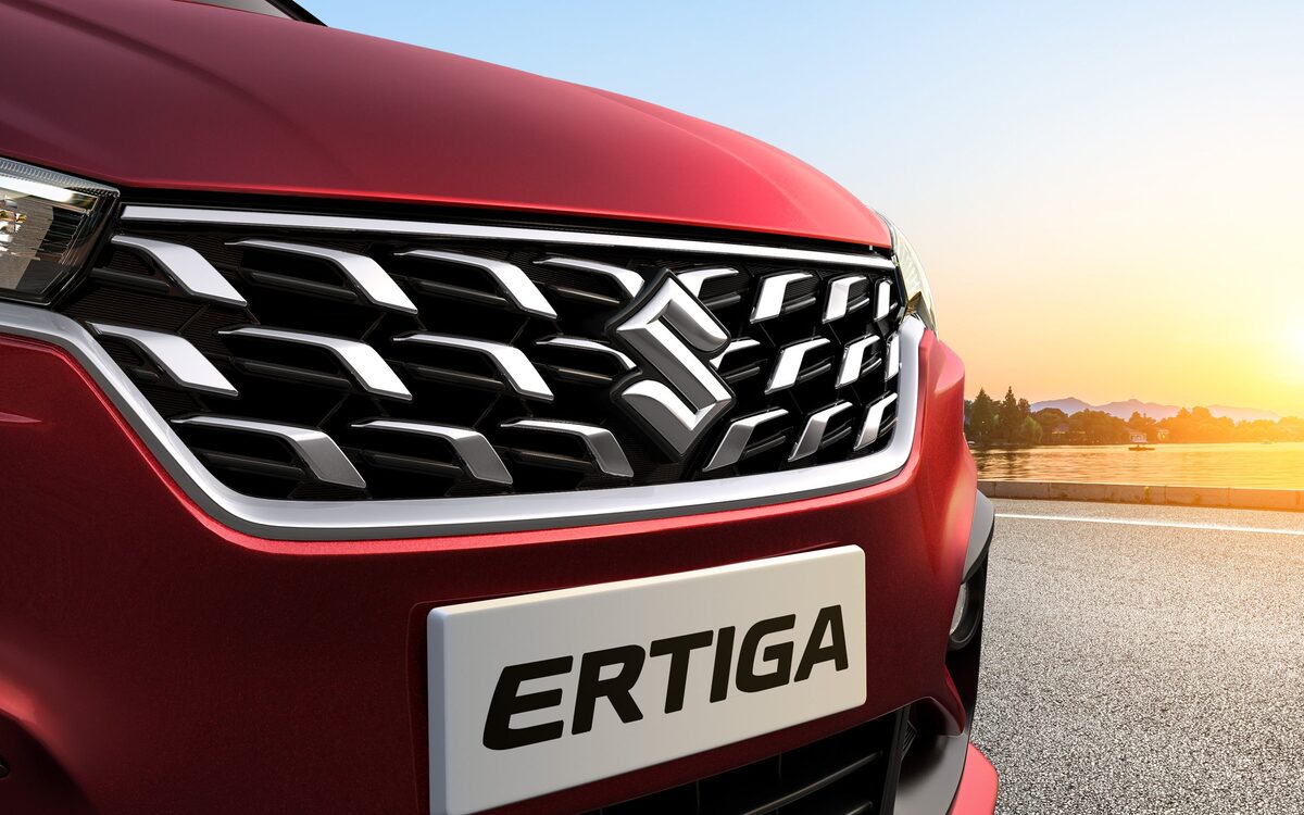 Close-up of the Ertiga's winged chrome front grille and number plate at sunset