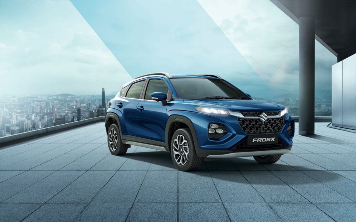Maruti Suzuki Fronx in blue, front three-quarter view on a city rooftop terrace