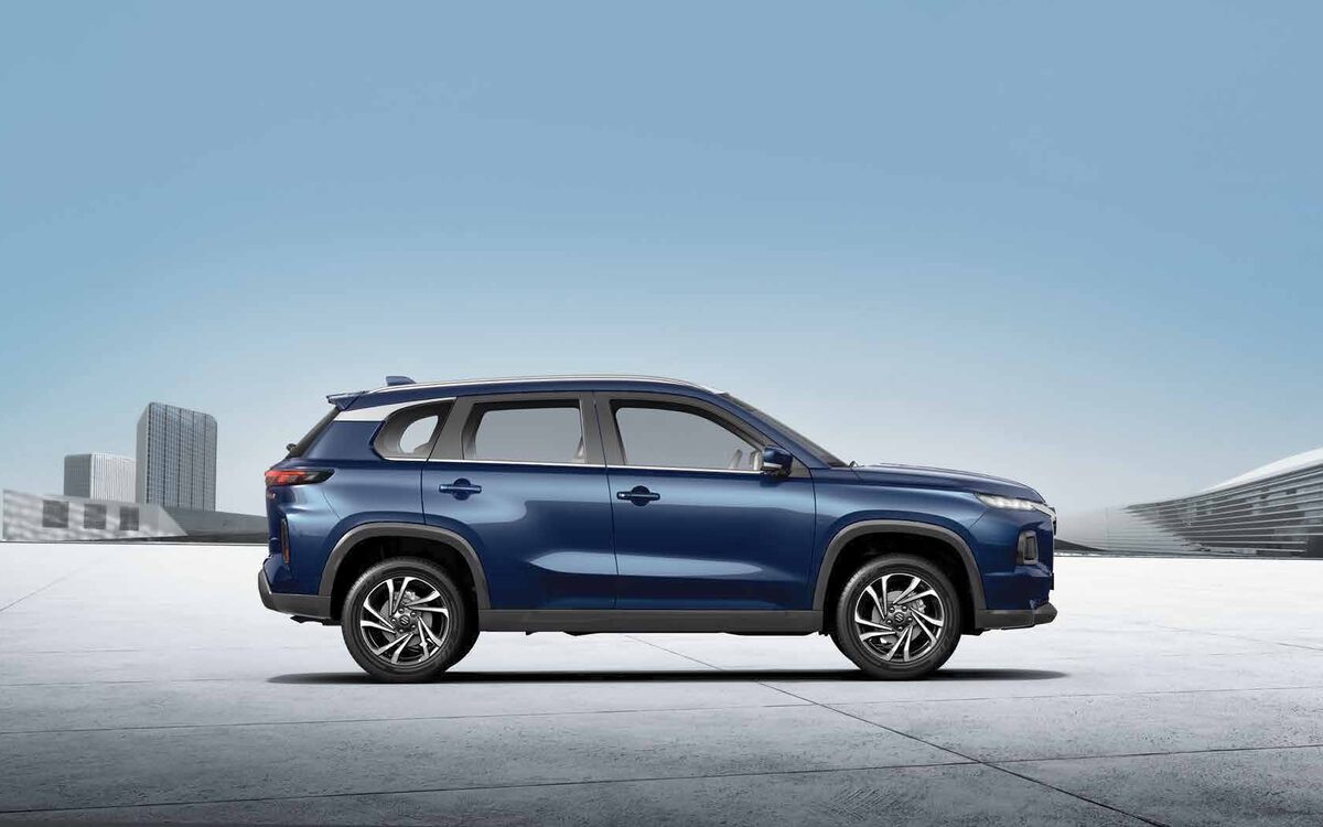 Maruti Suzuki Grand Vitara in Nexa Blue, side profile on a plaza