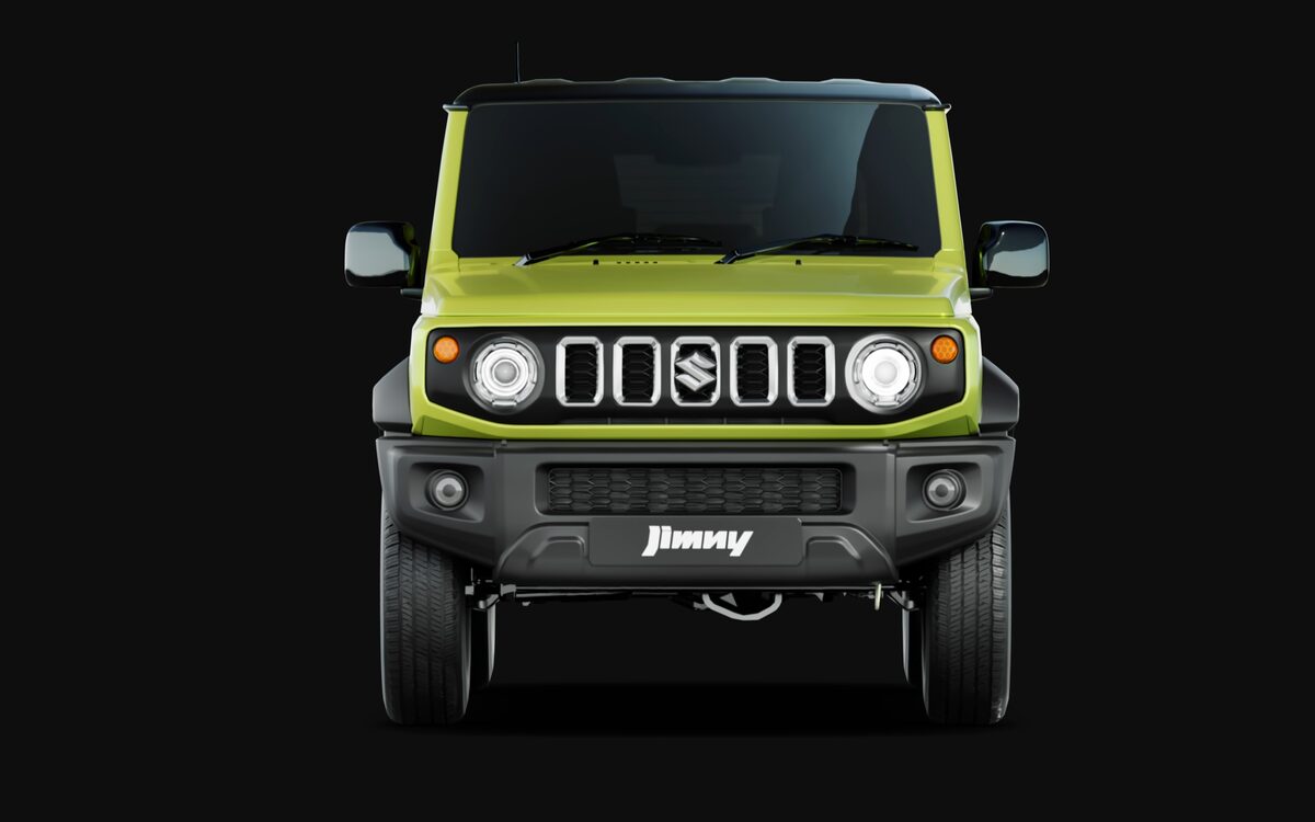 Front view of a yellow Jimny with black bumper and round headlamps on a dark background