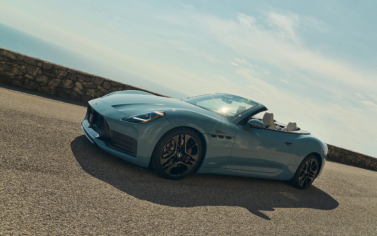 Maserati GranCabrio in light blue-grey with the roof down, front three-quarter view