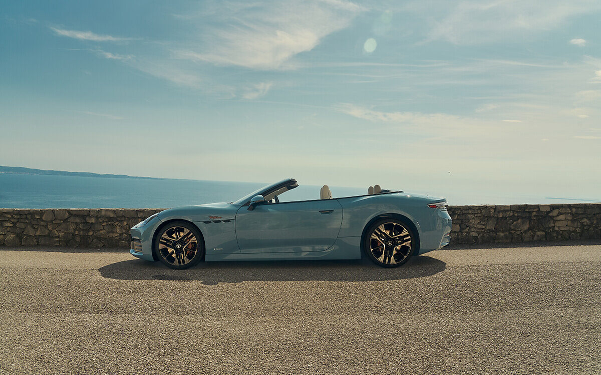 Maserati GranCabrio convertible with the roof down, side profile by the sea