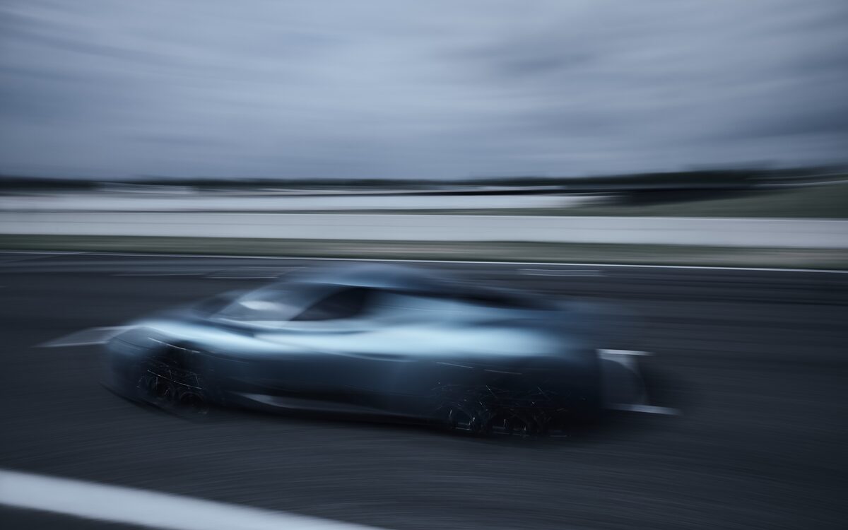 Maserati MCPURA at speed on a track with motion blur