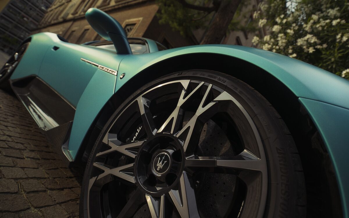 Low close-up of the MCPURA forged alloy wheel and wing on a cobbled street