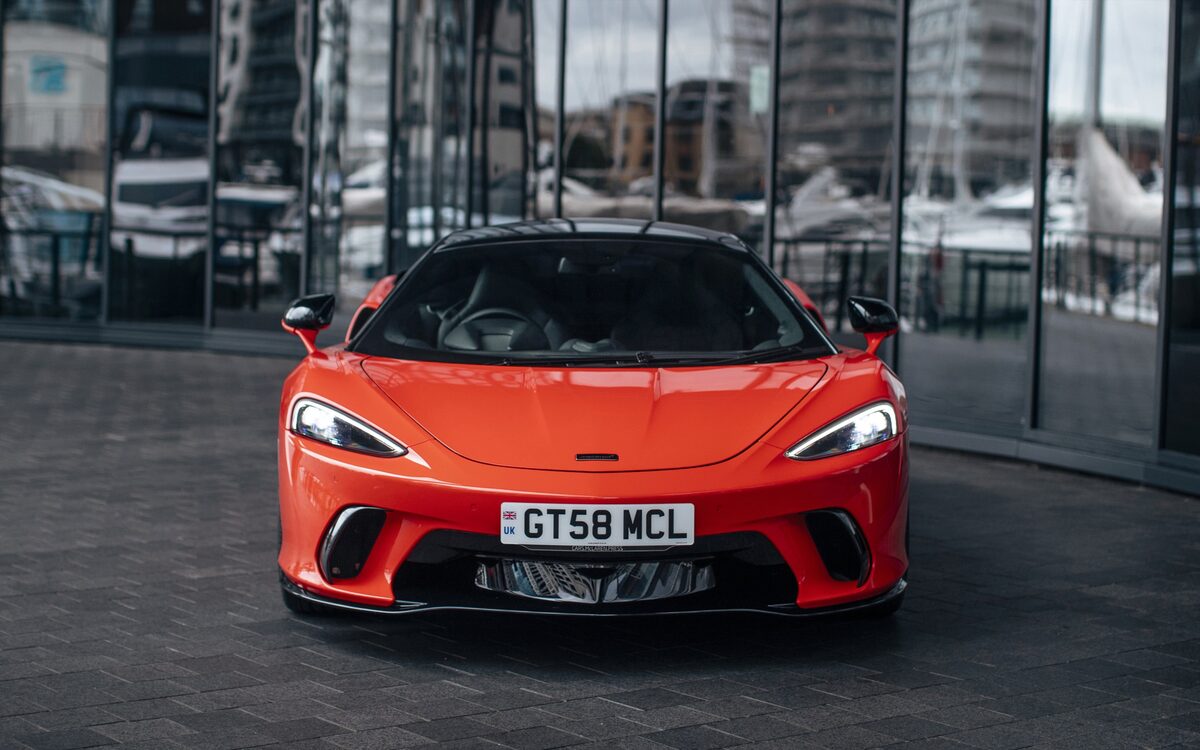 McLaren GTS in orange, head-on front view with the full-width headlamps