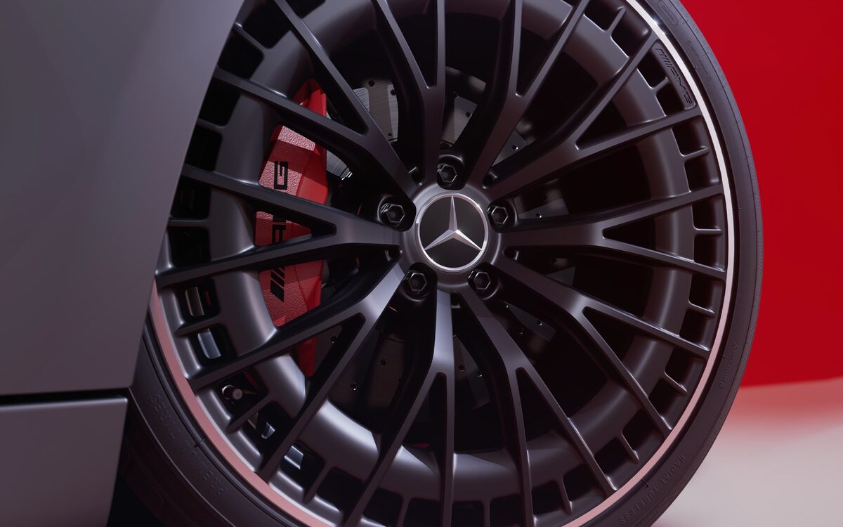 Close-up of a black multi-spoke AMG alloy wheel with red brake calliper