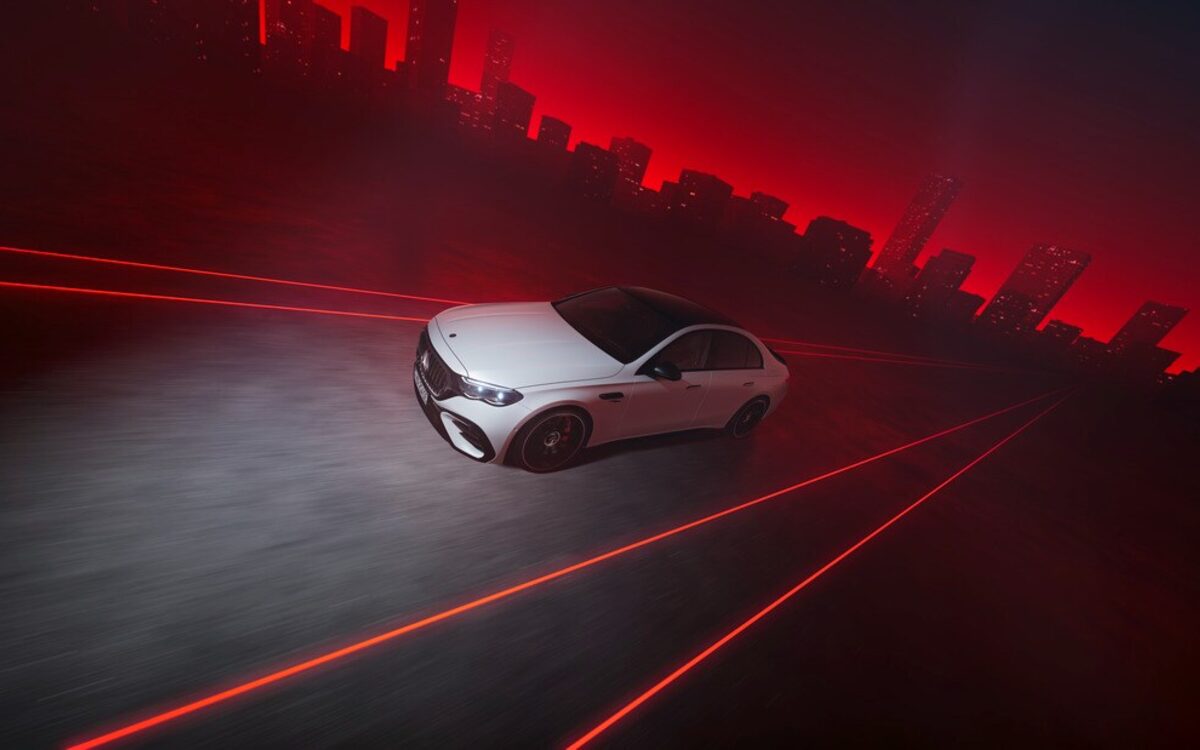 Mercedes-AMG E 53 Hybrid seen from above driving on a red-lit road at night