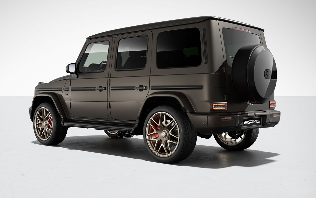 Mercedes-AMG G 63 in a matt olive-grey paint, rear three-quarter view with AMG badge on a white studio floor