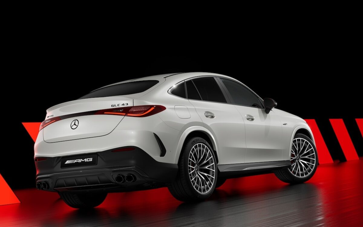 Mercedes-AMG GLC 43 Coupe in white, rear three-quarter view in a dark studio with red accents
