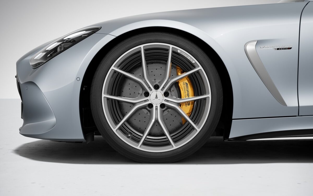 Close view of a silver Mercedes-AMG GT with forged alloy wheel and yellow brake caliper