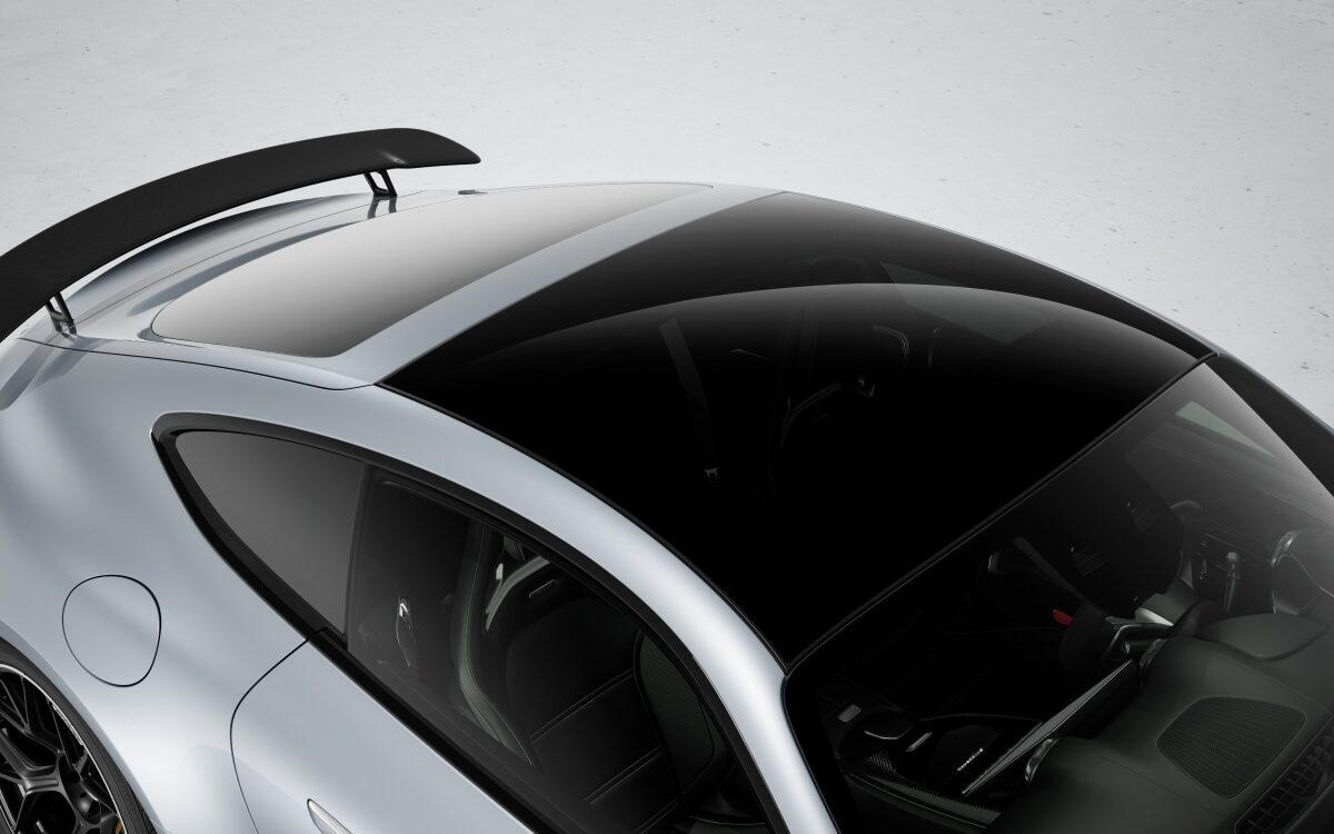Top view of the glass panoramic roof and rear spoiler on a silver Mercedes-AMG GT