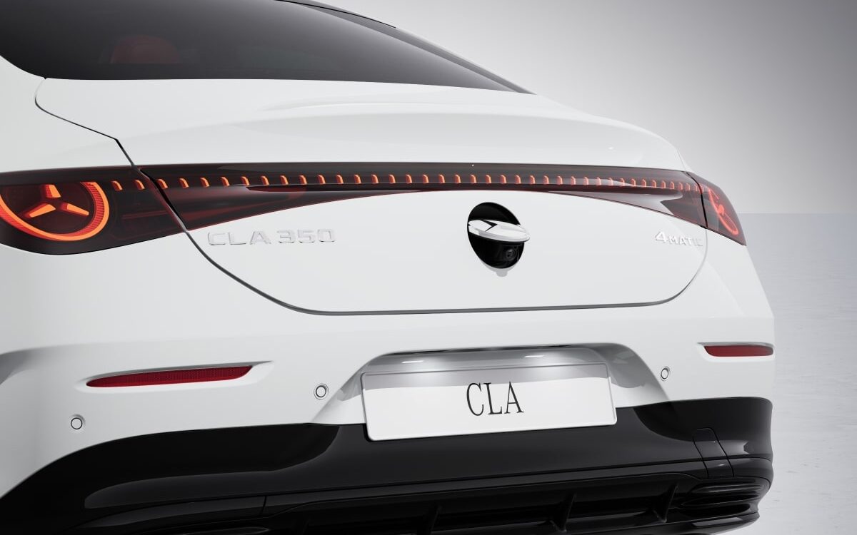 Rear of a white Mercedes-Benz CLA showing the full-width tail lamp with star-shaped lighting