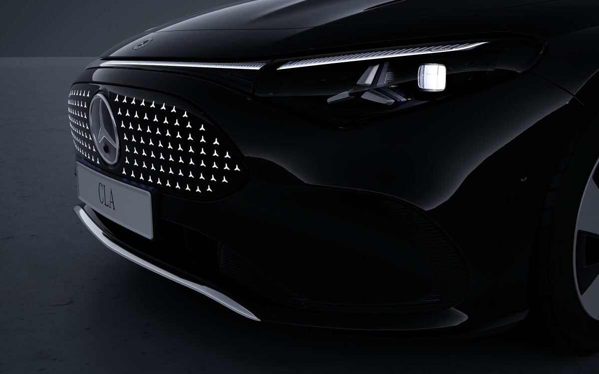 Black Mercedes-Benz CLA seen from the front corner showing headlamp and star-pattern grille