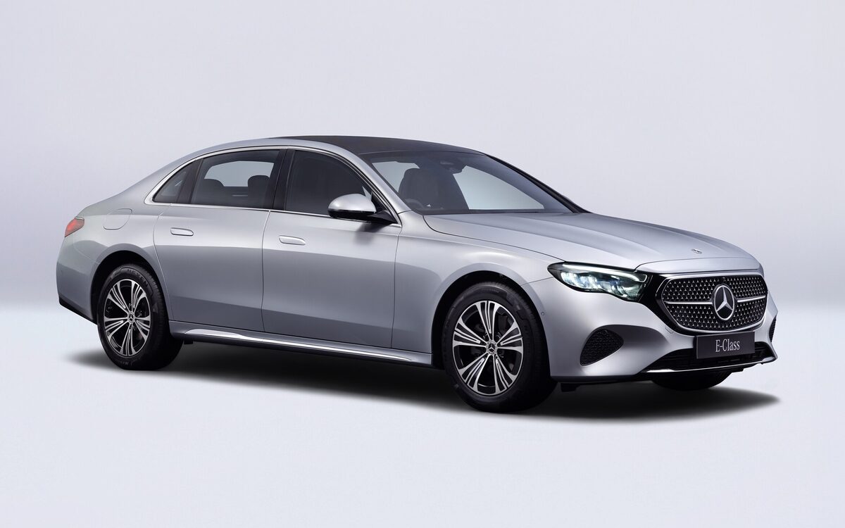 E-Class LWB in silver, front three-quarter view in a studio