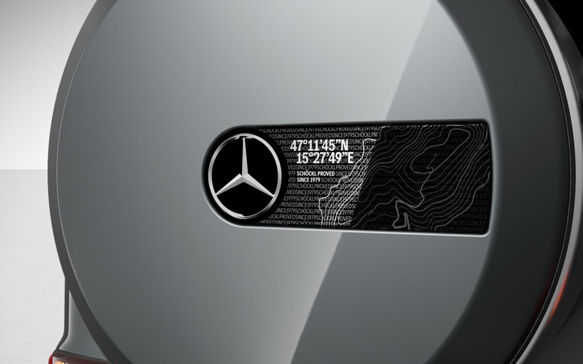 Grey spare wheel cover with Mercedes star and engraved terrain-map plate on the tailgate