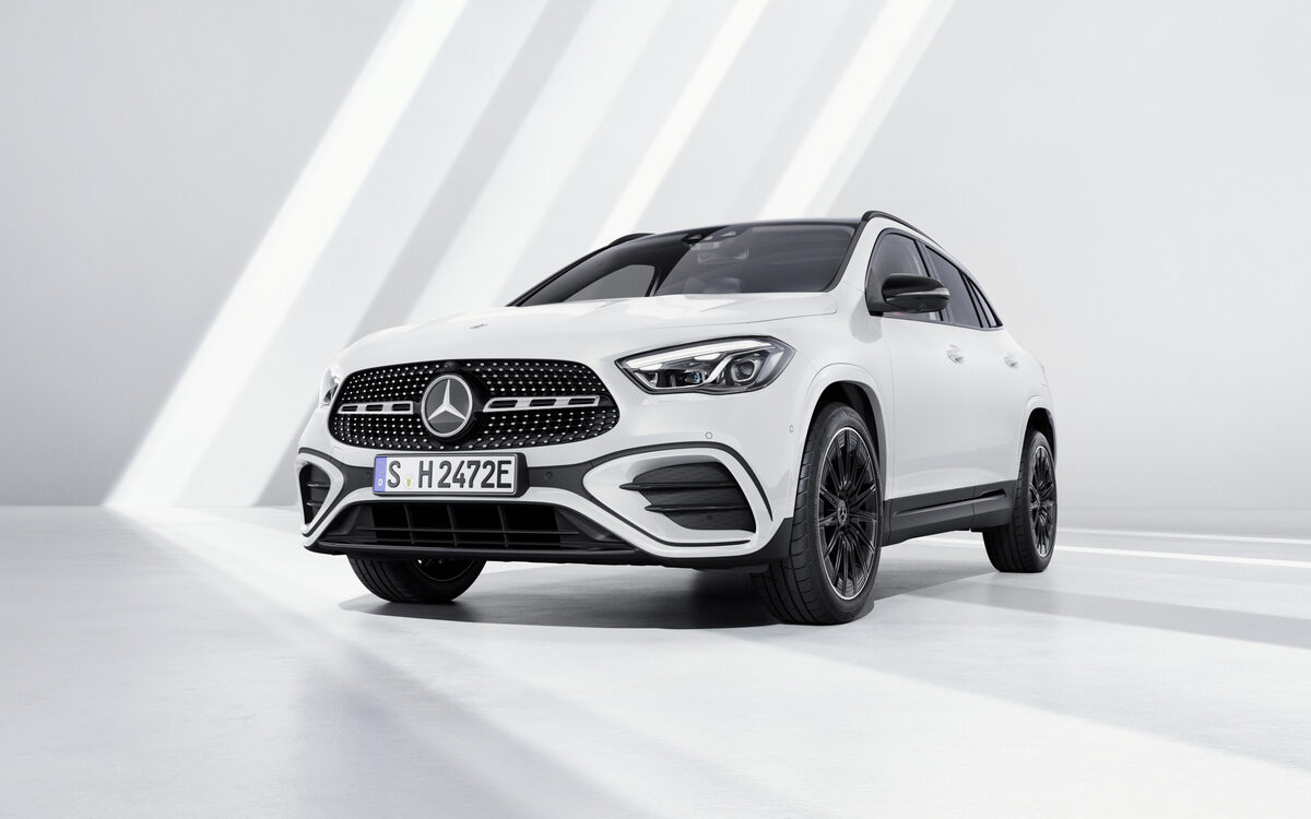 Mercedes-Benz GLA in white from a low front angle showing the diamond-pattern grille and headlamps
