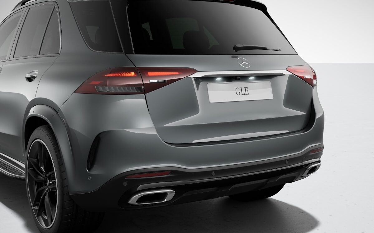 Grey Mercedes-Benz GLE with black alloy wheels seen from the rear quarter, showing the tailgate, tail lamps and exhaust trim