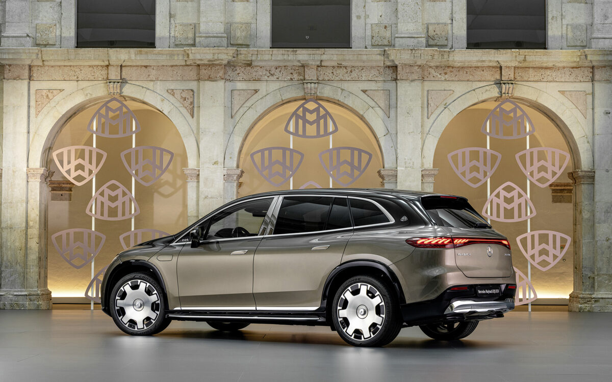 Mercedes-Maybach EQS SUV seen from the rear three-quarter angle in a courtyard