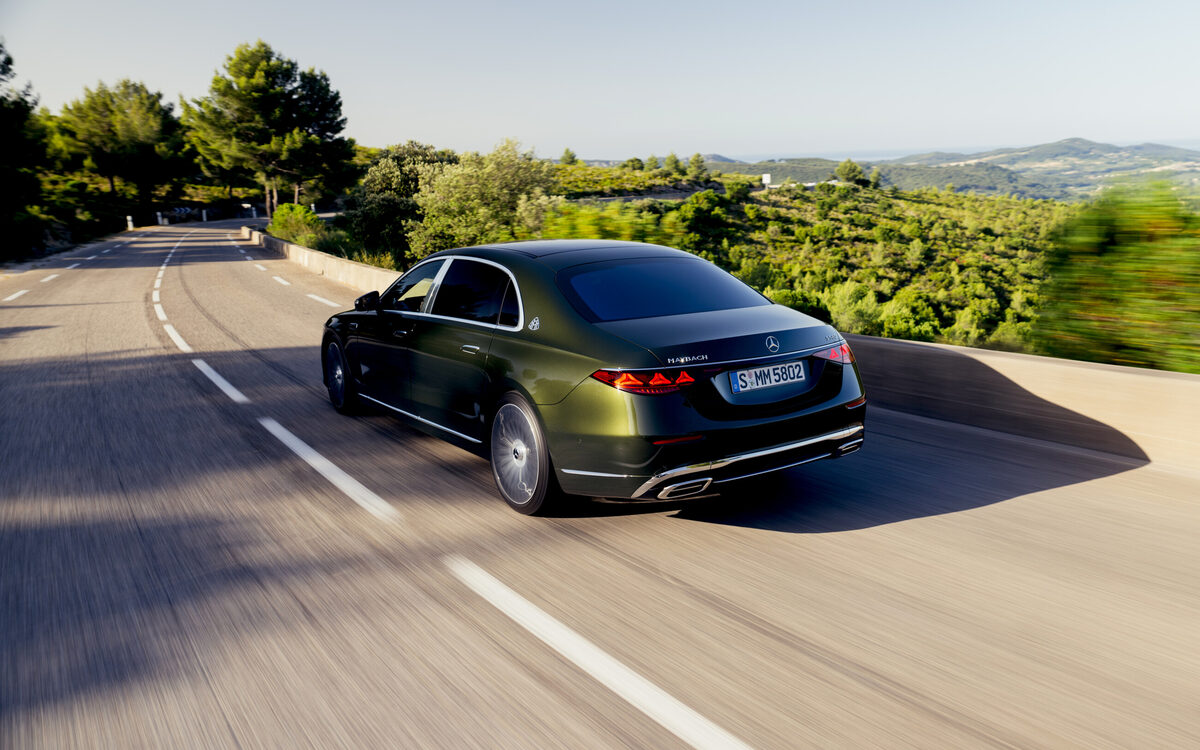 Olive green Mercedes-Maybach S-Class from behind and above, cornering on a winding road
