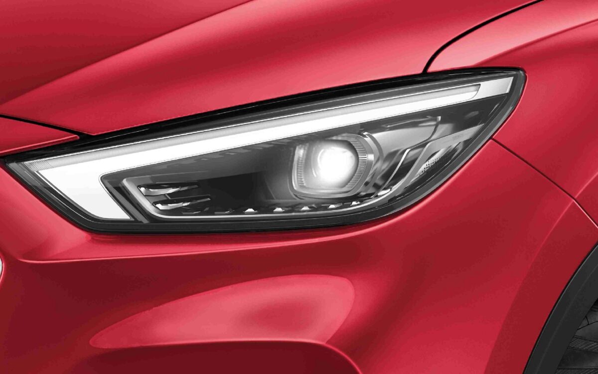 Close-up of the MG Astor full-LED headlamp on a red body