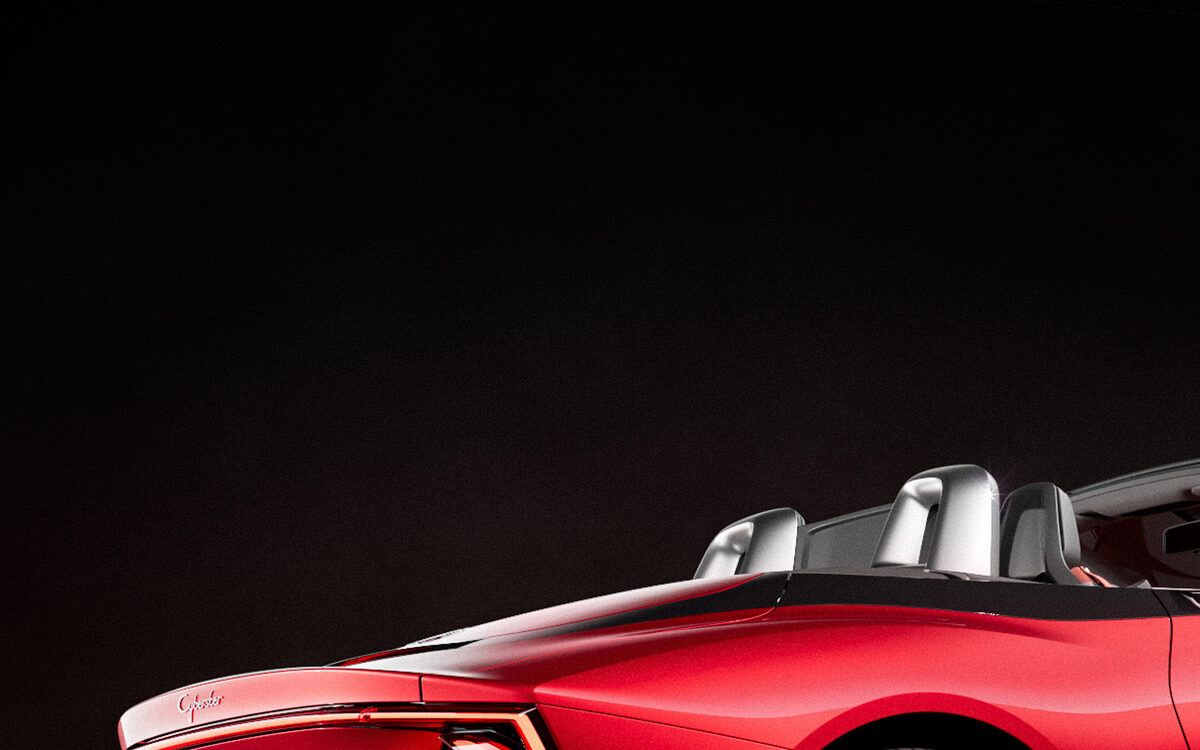 MG Cyberster in red from the rear corner showing the tail lamp and rear wheel on a glossy black floor