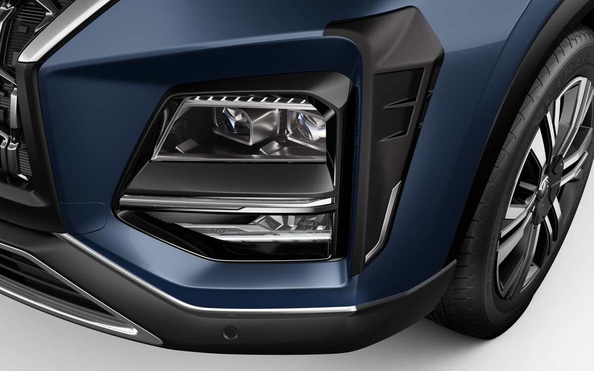Close-up of the MG Hector LED headlamp and fog lamp housing beside the front wheel