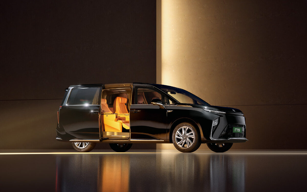 MG M9 with the electric sliding door open, showing the tan leather second row lit from inside