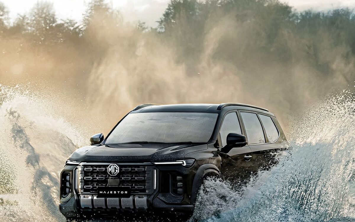 MG Majestor driving through a lake with water spraying around it