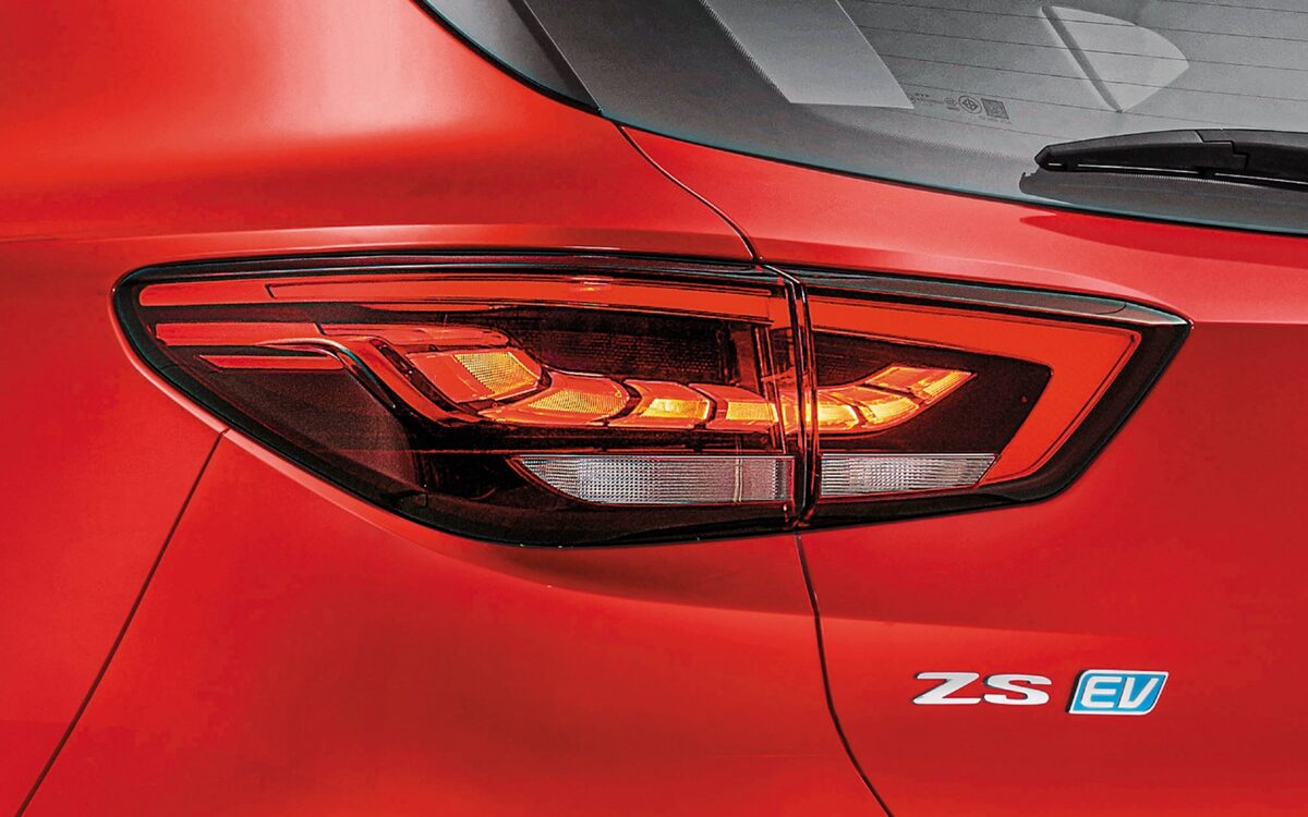 Close-up of the LED tail lamp and ZS EV badge on a red MG ZS EV