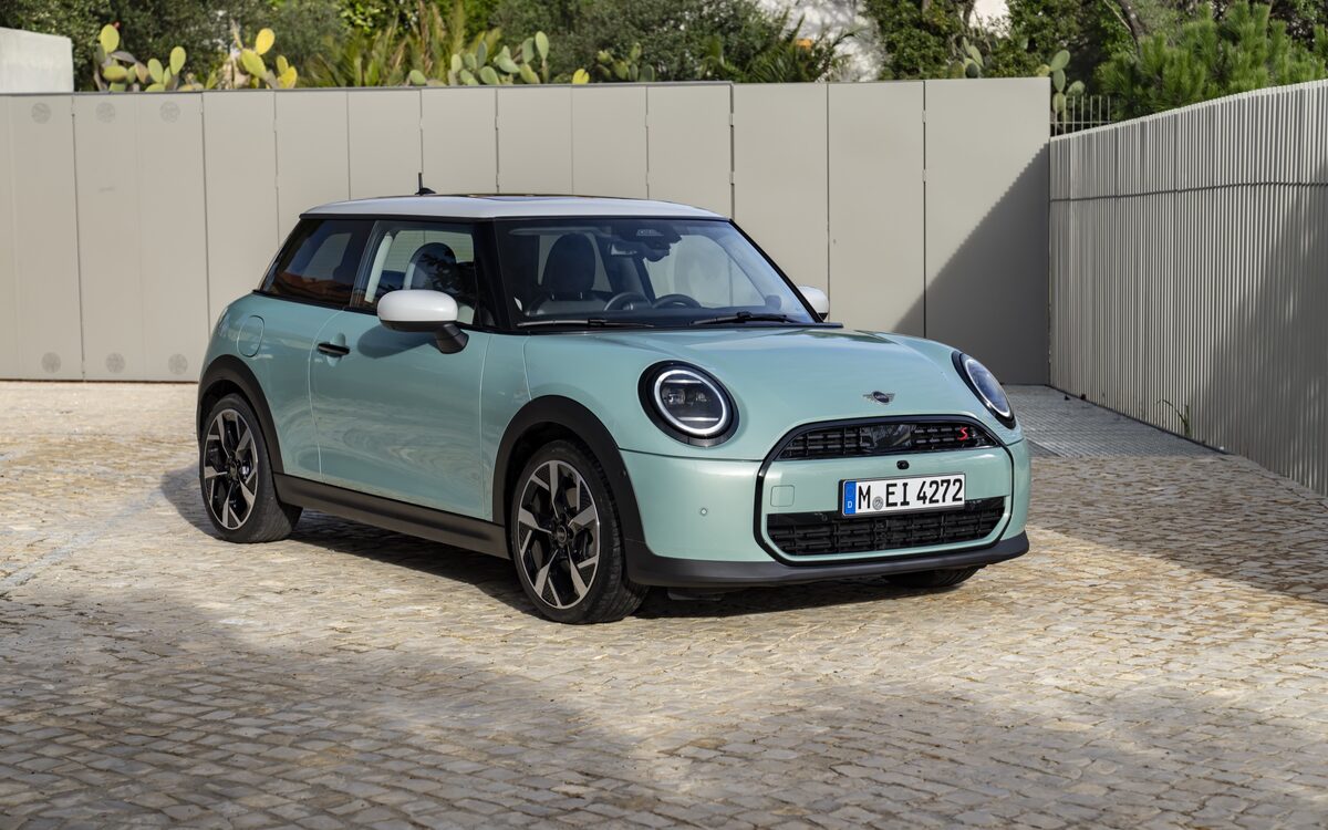 MINI Cooper S three-door in light green, front three-quarter view parked on cobbles