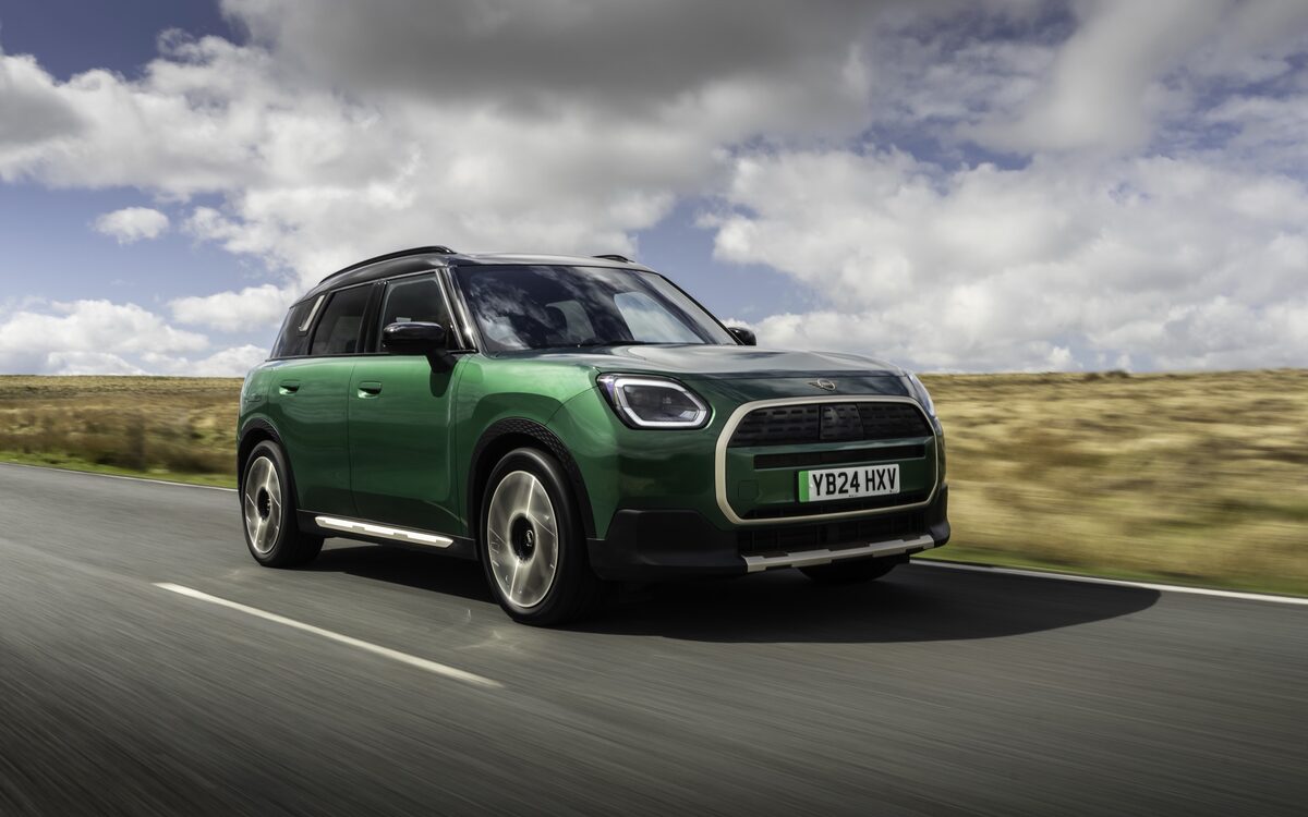 MINI Countryman Electric in green, front three-quarter view on a moorland road