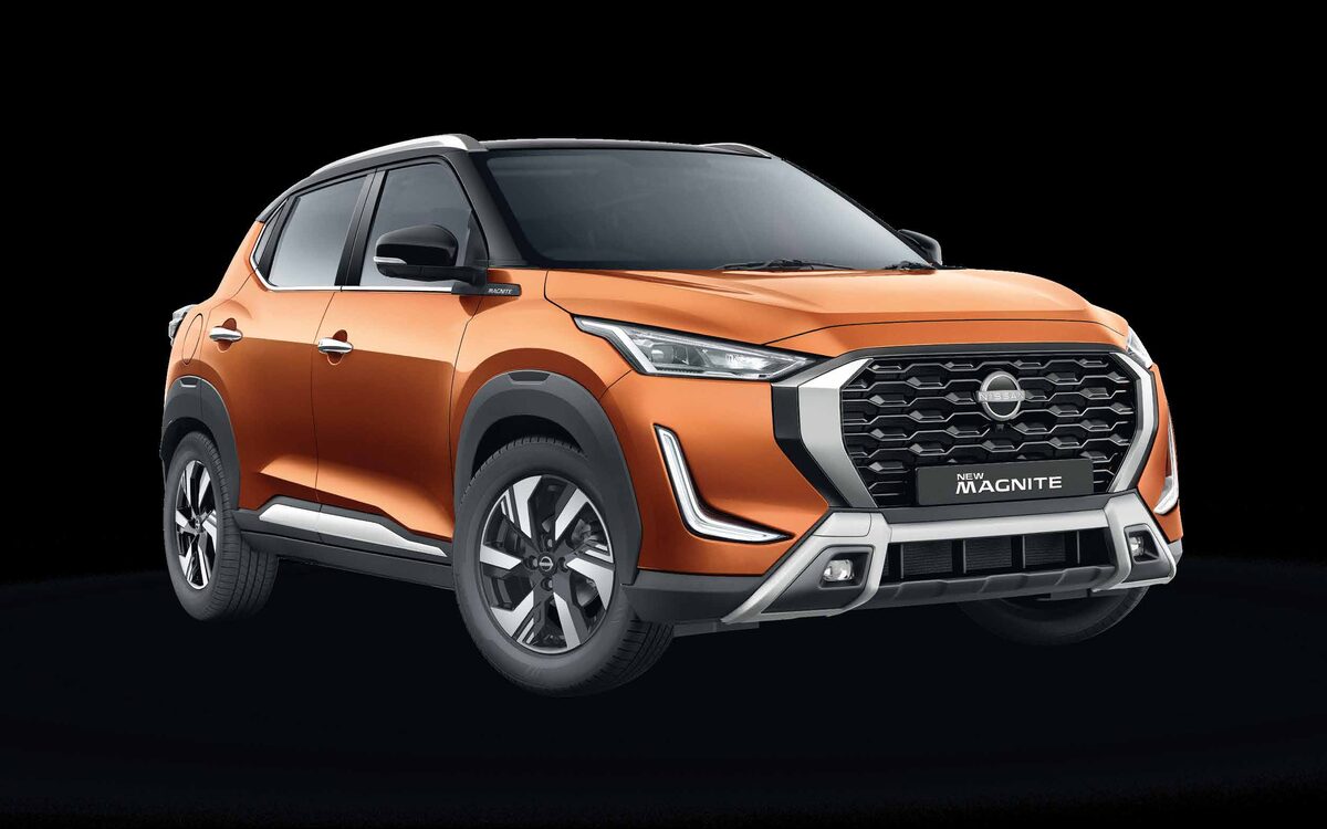 Nissan Magnite in Sunrise Copper Orange, front three-quarter view on a black studio background