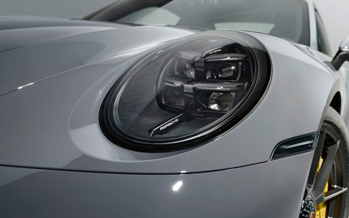 Close-up of the round LED matrix headlamp of the Porsche 911