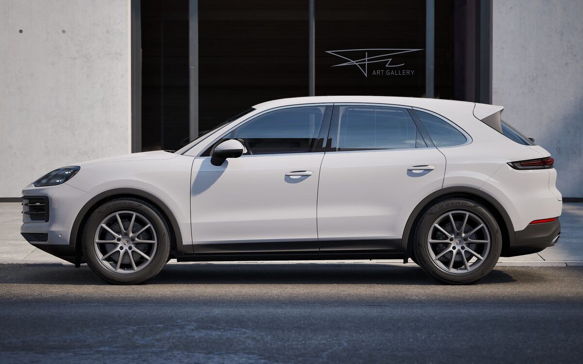 Porsche Cayenne in white, side profile on a city street in front of an art gallery