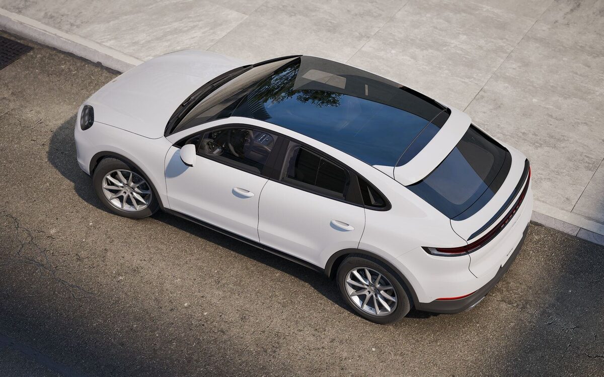 Porsche Cayenne Coupe in white seen from above and behind with the dark panoramic roof