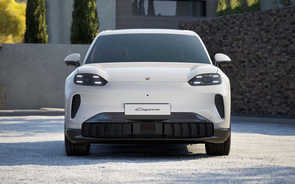Porsche Cayenne Electric in white, straight front view with the slim headlamps and lower air intake