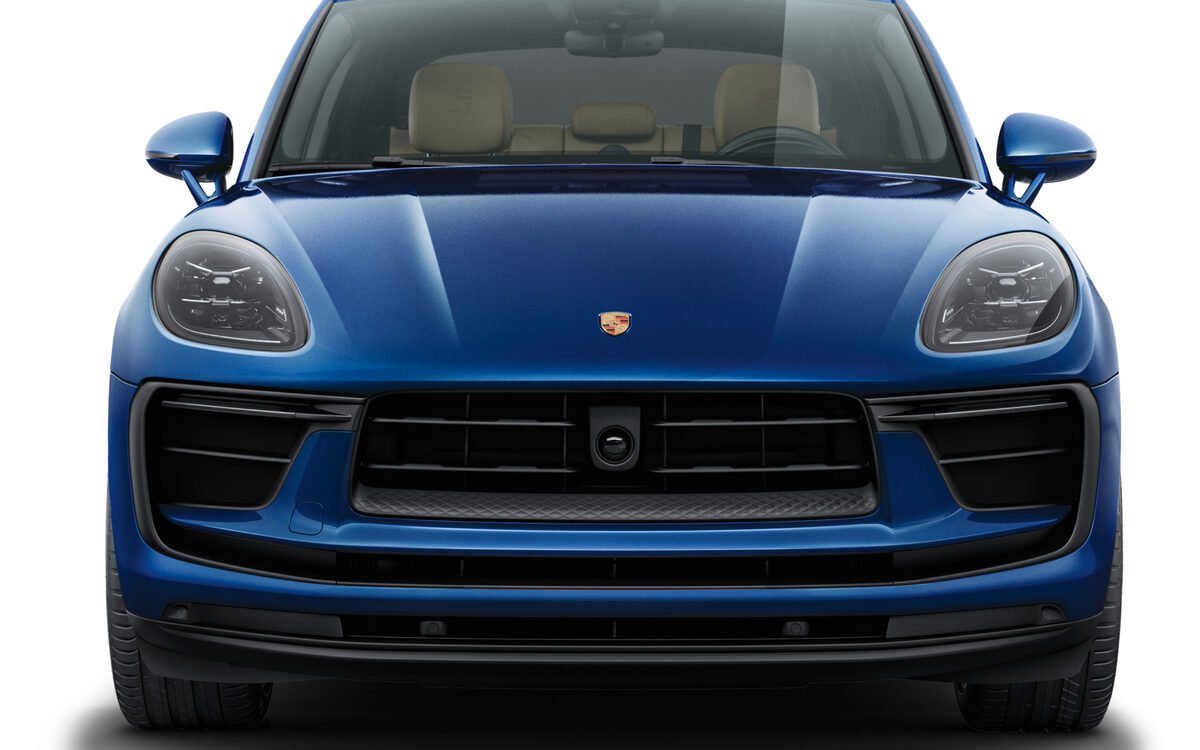 Blue Porsche Macan seen from the front on a white background