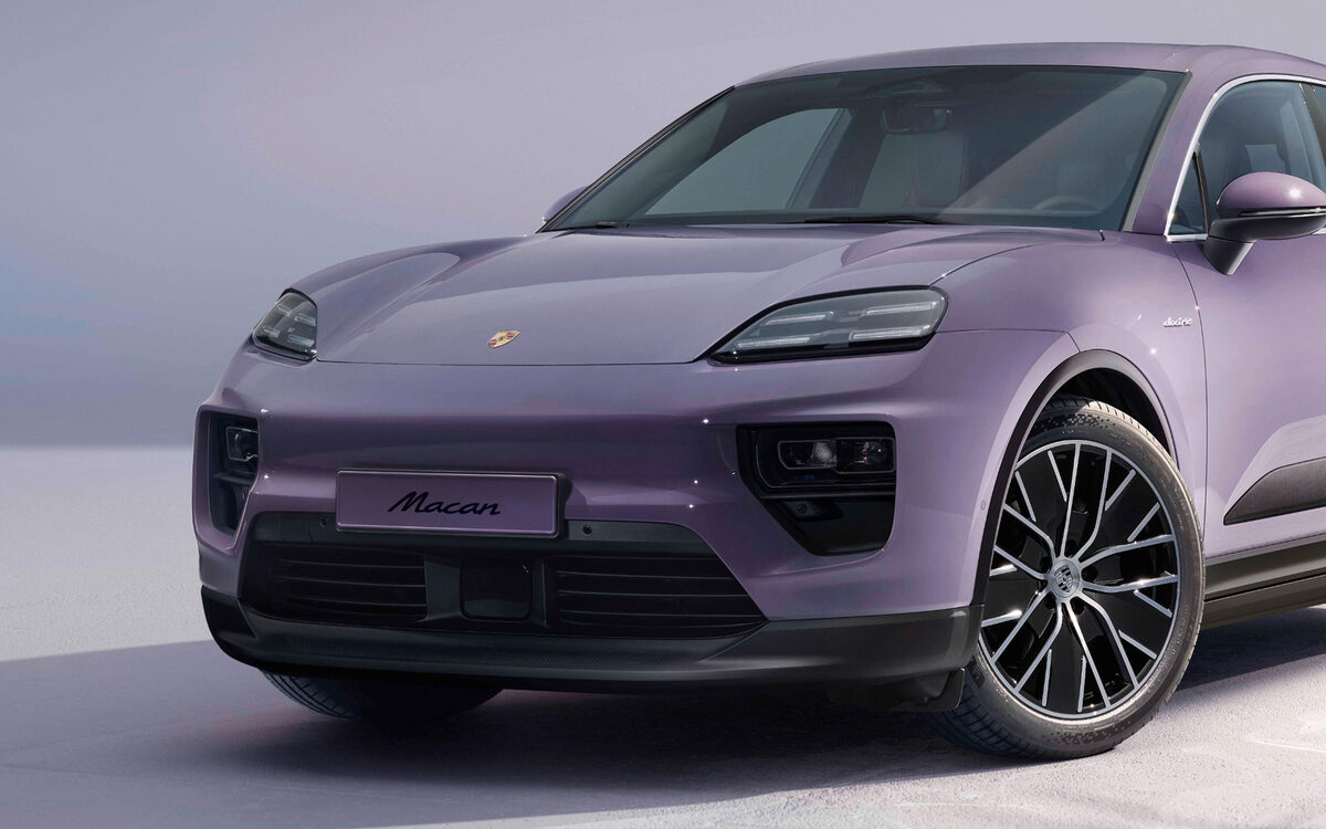 Porsche Macan Electric in lilac, front three-quarter view on a pale studio floor
