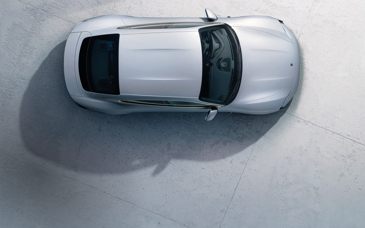 Silver Porsche Taycan seen from directly above on a concrete floor