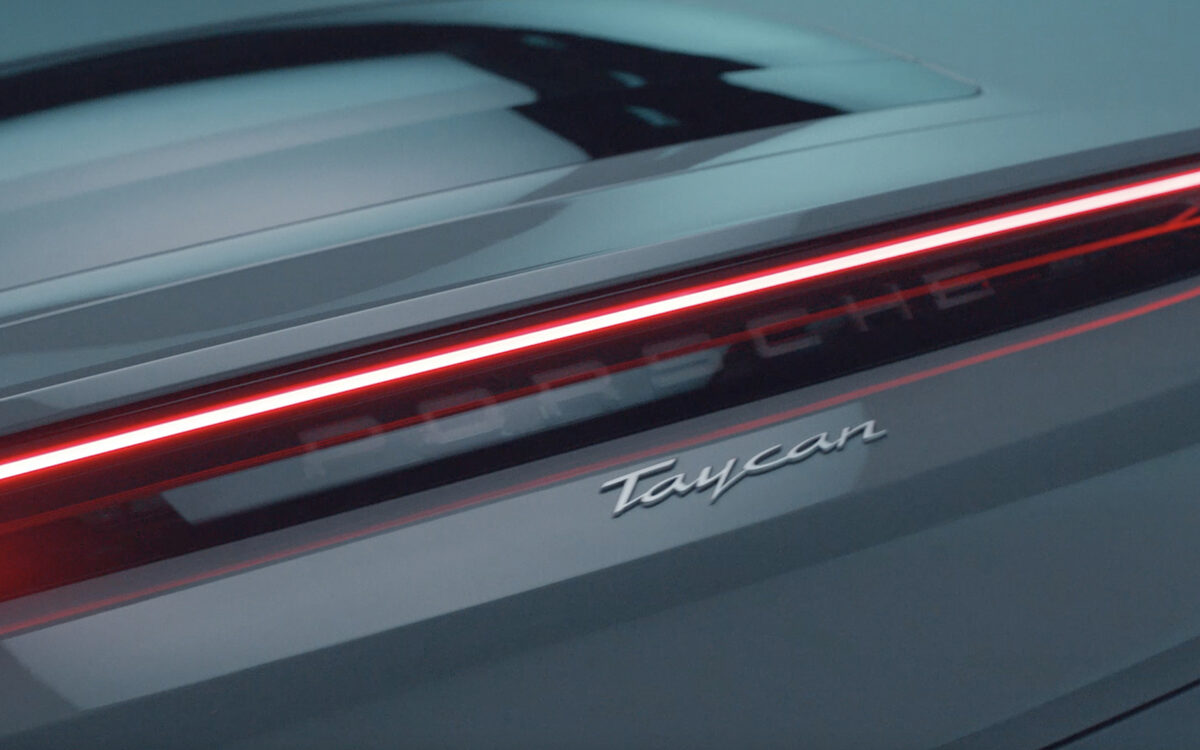 Close-up of the Porsche Taycan rear light strip with the Taycan badge