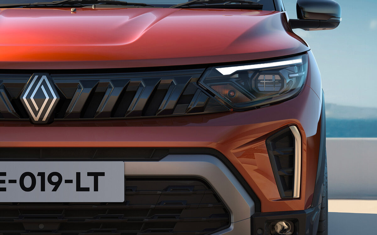 Close-up of the orange Triber front end with the Renault diamond grille and slim LED headlamp