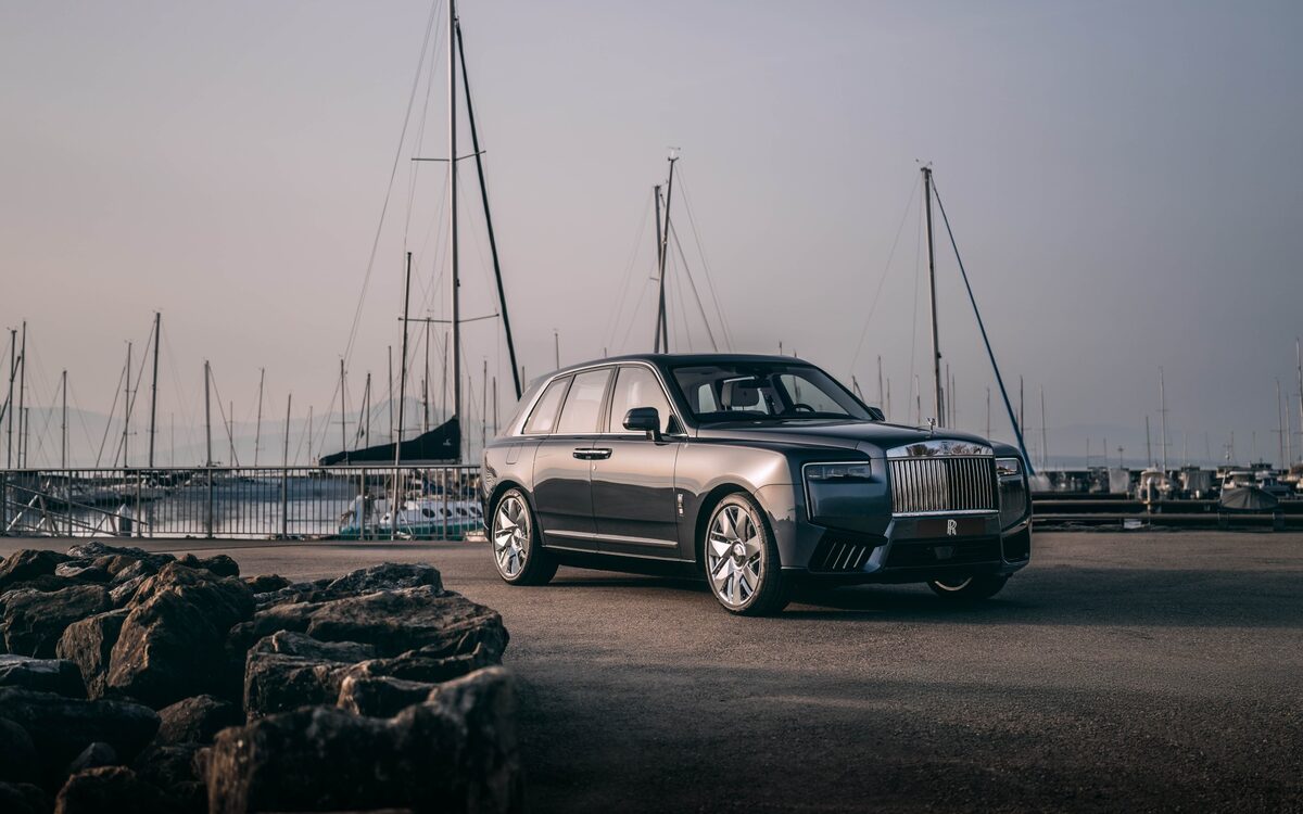 Rolls-Royce Cullinan front three-quarter view parked at a lakeside marina